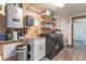 Well-organized laundry room with wood-paneled walls and modern washer, dryer, and utility sink at 7850 S Mooresville Rd, Indianapolis, IN 46113