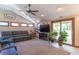 Bright living room boasts vaulted ceilings, large windows, and a sliding glass door to the outdoors at 7850 S Mooresville Rd, Indianapolis, IN 46113