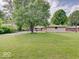 Expansive backyard with a detached garage and lush green lawn, ideal for outdoor activities and gatherings at 8071 Chiltern Dr, Indianapolis, IN 46268
