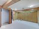 Unfinished basement area has painted white floors and wood-paneled walls at 8071 Chiltern Dr, Indianapolis, IN 46268