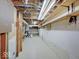 Unfinished basement features exposed ceiling beams and ductwork, plus a pegboard wall at 8071 Chiltern Dr, Indianapolis, IN 46268