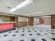 This basement features a tiled floor, wood paneling and a red bar area at 8071 Chiltern Dr, Indianapolis, IN 46268