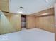 Unfinished basement area has painted white floors and wood-paneled walls at 8071 Chiltern Dr, Indianapolis, IN 46268