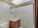 Small bathroom with vanity and toilet has patterned wallpaper at 8071 Chiltern Dr, Indianapolis, IN 46268