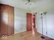 Bedroom featuring hardwood floors, a ceiling fan, closet, and doorway to another room at 8071 Chiltern Dr, Indianapolis, IN 46268