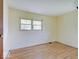 A sunny bedroom with light yellow walls and wood floors gets natural light from two windows at 8071 Chiltern Dr, Indianapolis, IN 46268