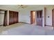 Bedroom featuring a ceiling fan, neutral carpet, and access to the bathroom at 8071 Chiltern Dr, Indianapolis, IN 46268