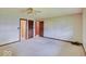 Spacious bedroom featuring neutral walls, a ceiling fan, closet, and doorway to the bathroom at 8071 Chiltern Dr, Indianapolis, IN 46268