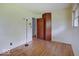 A light-filled bedroom showcases wood floors, an open door, and a large window at 8071 Chiltern Dr, Indianapolis, IN 46268