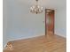 Cozy dining room featuring hardwood floors, light blue walls and chandelier lighting at 8071 Chiltern Dr, Indianapolis, IN 46268