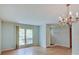 Bright dining room with hardwood floors, a chandelier, and a large window offering natural light at 8071 Chiltern Dr, Indianapolis, IN 46268