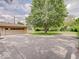 Long driveway leading to a detached garage in a lush, green backyard setting at 8071 Chiltern Dr, Indianapolis, IN 46268