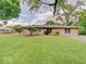 Charming single-story home with a well-manicured lawn and mature trees, showcasing curb appeal at 8071 Chiltern Dr, Indianapolis, IN 46268