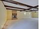 Spacious living room featuring a brick fireplace and exposed wood beam ceiling at 8071 Chiltern Dr, Indianapolis, IN 46268