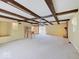 Large living room with exposed beams, a fireplace, and natural light at 8071 Chiltern Dr, Indianapolis, IN 46268