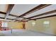 Expansive living room featuring exposed beams, a fireplace, and lots of natural light at 8071 Chiltern Dr, Indianapolis, IN 46268