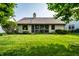 Green backyard featuring mature trees, a lush lawn and the home's exterior at 8223 Thoroughbred Run, Indianapolis, IN 46256