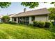 Lush backyard with well-maintained lawn and a screened-in porch at 8223 Thoroughbred Run, Indianapolis, IN 46256