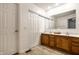 Bathroom with a double sink vanity, a large mirror, and a separate toilet and shower area at 8223 Thoroughbred Run, Indianapolis, IN 46256