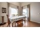 Bright dining area with large windows, hardwood floors, and a table with seating for four at 8223 Thoroughbred Run, Indianapolis, IN 46256