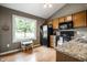 Bright kitchen features wooden cabinets, updated countertops, and a large window offering a view of the pond at 8223 Thoroughbred Run, Indianapolis, IN 46256