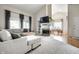 Spacious living room with a fireplace, built-in shelving, and seamless flow into the dining area at 8223 Thoroughbred Run, Indianapolis, IN 46256