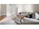 Comfortable living room featuring a sectional sofa, neutral tones, and plush carpeting at 8223 Thoroughbred Run, Indianapolis, IN 46256