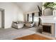 Bright living room featuring a vaulted ceiling, cozy fireplace, plush seating and plenty of natural light at 8223 Thoroughbred Run, Indianapolis, IN 46256