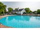 A sparkling outdoor swimming pool with a nearby clubhouse offers community relaxation at 8223 Thoroughbred Run, Indianapolis, IN 46256