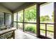 Relaxing screened porch with comfortable seating and views of the landscaped backyard at 8223 Thoroughbred Run, Indianapolis, IN 46256