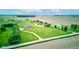 Wide aerial view of the property featuring a brick home on a large lot with lush greenery and a serene pond, showcasing its charm at 8371 N 400 W, Fairland, IN 46126