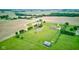 Scenic aerial image showing a large lot with mature trees, a pond, and a home with outbuildings in a countryside setting at 8371 N 400 W, Fairland, IN 46126