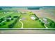 Aerial shot of a home on a large lot with a pond, green space, and outbuildings, perfect for peaceful country living at 8371 N 400 W, Fairland, IN 46126
