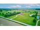 Expansive aerial view of a well-kept two-story home with a pond and ample green space, showcasing the property's serene setting at 8371 N 400 W, Fairland, IN 46126