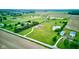 Sweeping aerial perspective of a house on a large lot with a pond, manicured lawn, outbuildings and privacy at 8371 N 400 W, Fairland, IN 46126