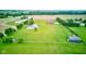 Picturesque aerial view of home, pond, manicured lawn, fence and outbuilding, showcasing the property's expansive outdoor space at 8371 N 400 W, Fairland, IN 46126
