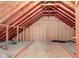 Unfinished attic showcases exposed rafters, awaiting your personal touch for a future renovation or creative conversion at 8371 N 400 W, Fairland, IN 46126