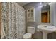 Standard bathroom with toilet, sink, and shower with patterned shower curtain at 8371 N 400 W, Fairland, IN 46126