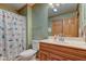 Cozy bathroom features a shower with curtain, vanity, and toilet at 8371 N 400 W, Fairland, IN 46126