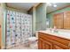 Cozy bathroom features a shower with curtain, vanity, and toilet at 8371 N 400 W, Fairland, IN 46126