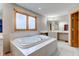 Bright bathroom boasts a large soaking tub and large window at 8371 N 400 W, Fairland, IN 46126