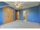 Spacious bedroom with access to a bathroom, natural lighting, bright blue walls, a closet, and carpet at 8371 N 400 W, Fairland, IN 46126