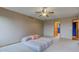 Carpeted bedroom featuring two entryways, a ceiling fan, and neutral-colored walls at 8371 N 400 W, Fairland, IN 46126