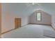 Bonus room with dormer window and neutral carpeting. Door provides access to storage at 8371 N 400 W, Fairland, IN 46126