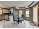 Bright breakfast nook featuring a glass table, white cabinets, and windows with a view, perfect for casual dining at 8371 N 400 W, Fairland, IN 46126