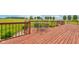 Secluded outdoor wooden deck featuring a table and chairs overlooking the tranquil backyard with a lush lawn and privacy shrubbery at 8371 N 400 W, Fairland, IN 46126