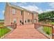 Spacious wooden deck connecting to the brick house, featuring railing and access to the lush backyard at 8371 N 400 W, Fairland, IN 46126