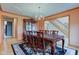 Elegant dining room featuring a chandelier, wood table, and staircase access, perfect for Gathering gatherings at 8371 N 400 W, Fairland, IN 46126