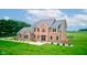 Stately brick home with lush front lawn, manicured bushes, and a well-designed facade at 8371 N 400 W, Fairland, IN 46126