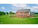 Large brick home with a deck and expansive lawn, set in a serene and private setting at 8371 N 400 W, Fairland, IN 46126